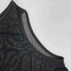 Detailed close-up of black mesh fabric with wavy jacquard texture and neat stitching