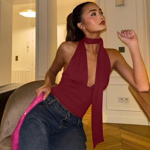 Detail of burgundy halter neck top with long scarf ties and open back design