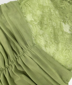 Detail of avocado green mesh fabric with ruching and intricate floral lace stitching