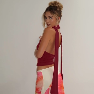 Detail view of the backless halter top featuring long tie ribbons and a slim fit design