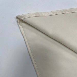Detailed close-up showing the smooth hemline and texture of the cream lace dress fabric