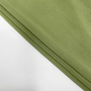 Close-up of the breathable grass green mesh fabric with a detailed honeycomb structure