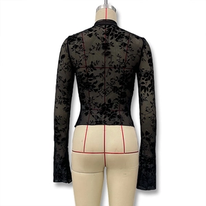 Detailed back view of a slim fit sheer black lace blouse with elegant floral patterns