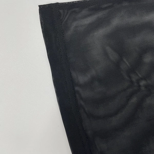 Close-up of black mesh fabric detail with fine texture and high-quality edge stitching