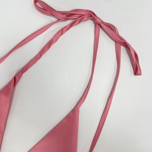 Detail of pink satin halter neckline with elegant tie strings and soft silk texture