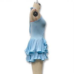 Detail view of light blue halter dress featuring side buttons and layered ruffle hem