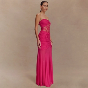 Detail of rose red strapless maxi dress featuring lace patchwork and ruched texture