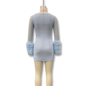 Detail of light blue mesh dress featuring layered ruffle cuffs and slim bodycon fit