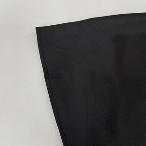 Detail shot of black satin dress with high-quality single needle flat stitching finish