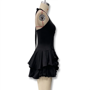 Detail of black halter neck dress with ruffled layers and side button design details