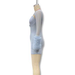 Detail of light blue mesh dress with mesh cutout and ruffled long sleeves on mannequin