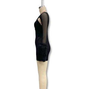 Detailed view of sheer mesh long sleeves with ruffled cuffs on a black bodycon dress