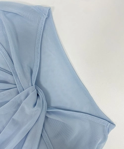 Detail of light blue mesh fabric featuring an elegant twisted knot design and fine stitching