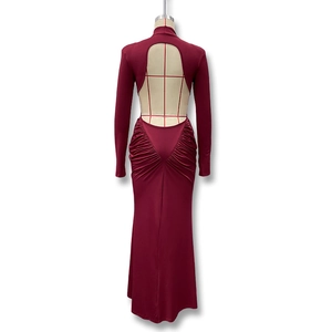 Detail view of backless design and ruching on a burgundy long sleeve slim fit dress