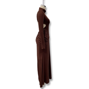 Detail of side waist cutout and ruched texture on long sleeve brown maxi dress