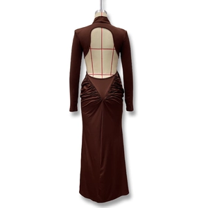 Detail view of deep U-shaped backless design with ruched detailing on a brown maxi dress