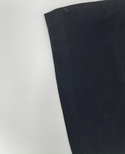 Detail of black mesh fabric with semi-transparent texture and double-needle stitching
