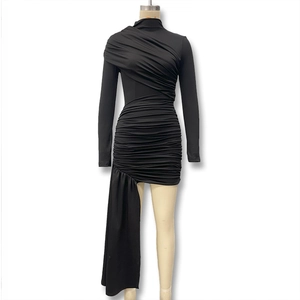 Detailed view of black ruched dress with asymmetric hem and elegant mock neck design