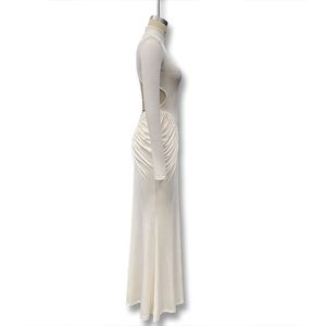 Detail of ruched waist and side cutout on a long sleeve white high neck maxi dress