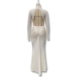 Detail view of the open-back design and ruched mermaid hem on the cream maxi dress