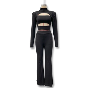 Detail of slim fit high neck hollow out top and flared pants set in black stretchy fabric