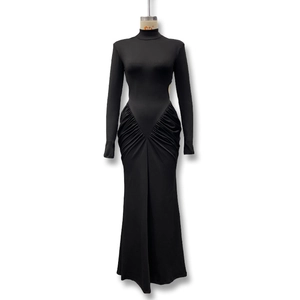 Detail of ruched fabric and side waist cut-out on this elegant long sleeve black maxi dress
