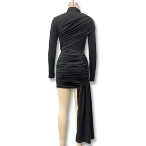 Detail of black slim fit dress featuring dense ruching and elegant long trailing ribbon