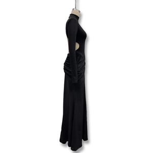Detail view of the sleek waist cutout and draped ruching on this black bodycon maxi dress