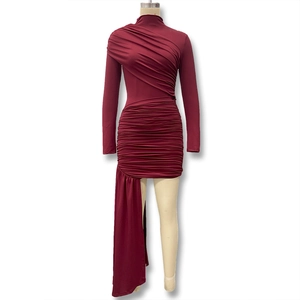 Close-up of wine red slim fit dress featuring ruched texture and asymmetric drape detail