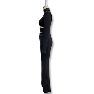 Detail view of high-stretch knit jumpsuit showing waist cutout and slim fit silhouette