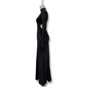 Detail view of the side cut-out and ruched waist on this black long sleeve evening gown