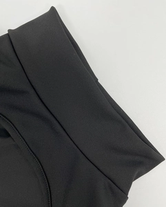 Detail of high-waisted wide yoga jumpsuit showing flatlock seams and premium stretch fabric