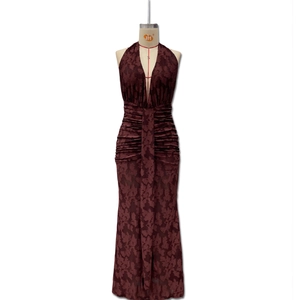 Detailed view of deep wine red burnout floral fabric and waist ruching on the maxi dress