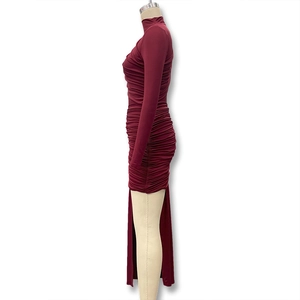 Detail view of burgundy ruched dress featuring side slit and high elasticity fabric