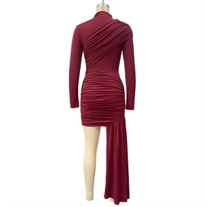 Detail of burgundy ruched bodycon dress with asymmetric ribbon hem and long sleeves