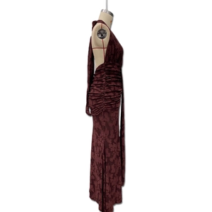 Detail of deep red backless mermaid dress with pleats and jacquard floral texture