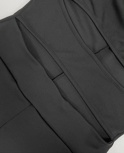 Close-up detail of the black cutout design and stitching on the slim fit bodysuit