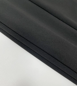 Detailed macro view of the premium high-density black knitted fabric with matte texture