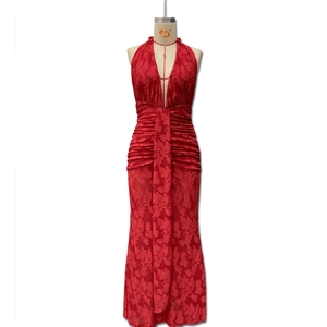 Detail of red deep V-neck halter dress with textured jacquard fabric and pleated design