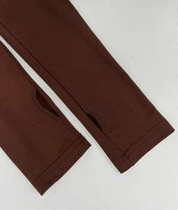 Close-up of chocolate brown sleeve with thumbhole design and reinforced flatlock stitching