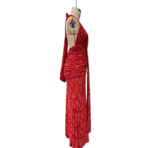 Close-up of red halter dress featuring floral jacquard texture and ruched body details