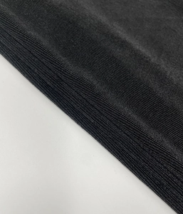 Close-up detail of the black ribbed knit fabric texture on this elegant slim fit dress