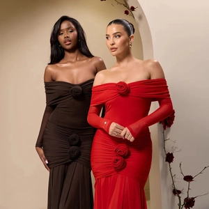 Detail of off-shoulder evening dress with 3D rose flower accents and pleated fabric texture