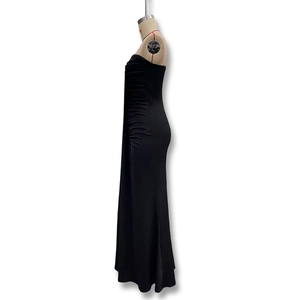 Detail view of the side ruching and slim fit texture on this elegant black maxi dress