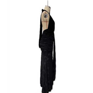 Detail of the backless design and ruching on the black backless fishtail evening dress