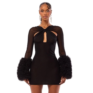 Detail of elegant black mesh mini dress with plush fur cuffs and cut-out chest design