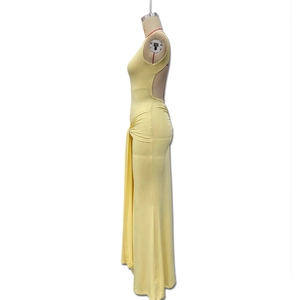 Detail of the side waist knot and ruching on a light yellow backless maxi dress