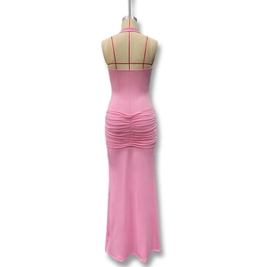 Detail view of the ruched back design and sleek floor-length hem on pink halter dress