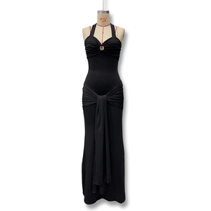 Detail of black halter dress featuring a metal ring with pleated bust and crisscross straps