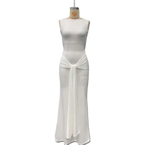 Detail view of white sleeveless maxi dress featuring elegant waist pleats and side ribbons